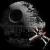 Pixelated grayscale image of a stylized skull with a curved top and hollow eye sockets against a black background.