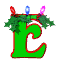 Green letter E with red outline, holly leaves, and three colored lights (red, blue, pink) on top; animated changes in leaf position.