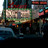Pixelated static image showing a blurred architectural structure with green and brown tones, partially obscured by dark and light pixel clusters.