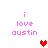 Pixelated text 'i love austin' in pink with red and pink heart icons on white background.