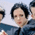 A 2x2 contact sheet of four animated frames showing a band member in various poses and outfits with visible pixelation and color artifacts.