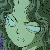 Pixelated static image of a light-colored, abstract, rounded shape with dark green and black pixel clusters surrounding it.