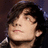 A pixelated image of a person with dark hair and light skin, accompanied by cyan text on black background listing attributes like 'hot!', 'cute', 'funny', 'cool' and describing them as 'one thing and one thing only... more than one thing but look at him'.