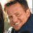 A pixelated image of a smiling man in dark clothing against a blue background with white text reading 'did you'd be not hear me say DUUUDE'?
