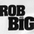 Black pixelated text on a light gray background, displaying 'ROB BIG' in large blocky letters with visible anti-aliasing and slight blurring.