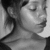Black-and-white pixelated portrait of a person with closed eyes, dark hair, and visible facial features including lips and nose.