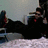 A pixelated image shows a person in dark clothing reclining on a light surface with a dark background, alongside a cyan text graphic reading "I Love My Bomi" on black.