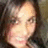 Pixelated close-up of a person's face with light skin tone, dark hair, and neutral expression against a dark background.