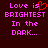 Pixelated text reads "Love is BRIGHTEST In the DARK..." with a red heart symbol replacing the 'i' in 'is' on the left side of the image.