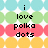 Pixelated text 'i love polka dots' centered over horizontal color bands with white starbursts on a light blue background.