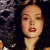 Static 50x50 pixel icon showing a close-up of a person's face with dark hair and red lips against a dark background, rendered in low-resolution pixel art style.