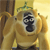 Pixelated image of a monkey-like creature with light brown fur, dark facial markings, and a green crown-like shape on its head, set against a yellow background.