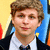 Pixelated portrait of a person with light brown hair wearing a white shirt, black jacket, and bow tie against yellow and blue background.