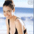 A pixelated image of a woman with dark hair in an updo wearing a black swimsuit on a beach, next to green text reading 'Original Icons .com' on a solid background.