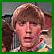 A pixelated contact sheet showing two frames of an animated icon featuring a person with light brown hair and a red background with repeated green text "HUH".