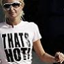 A person wearing a white t-shirt with bold black text "THAT'S HOT!" and dark sunglasses, standing against a dark background.