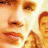 Pixelated close-up of a person's face with warm tones and bright lighting, alongside green text on dark background.
