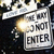 A rectangular sign with 'WE DO NOT ENTER' text, surrounded by blurred background elements including a bright light source.