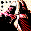 Black sneakers with pink laces, red-and-black striped socks, and black star symbols on a light background.