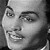 Black-and-white pixelated close-up of a person's face showing eyes, nose, mouth, and partial hair, with visible pixelation and grayscale tones.