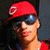 A person wearing a red cap with white circular logo, dark sunglasses, and red shirt appears in four ; the rightmost is blank