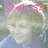 Pixelated image with pink text 'Greg (33)' overlaid on a blurred background featuring light and dark tones.