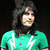 A person with long dark hair appears in multiple poses: wearing a green shirt with white patterns, a white shirt, and a blue shirt with dark patterns, with arms raised in one view.