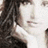 A pixelated image of a person with long dark hair, showing partial text overlays in black rectangular boxes.