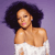 Pixelated image of a person with dark curly hair wearing a white off-shoulder top against a purple background.