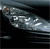 A static pixelated image shows a dark background with a light-colored, blurry, elongated object resembling a vehicle or animal in motion, with scattered bright highlights.