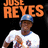 Pixelated image of a person in a white baseball jersey with blue trim and a blue cap, standing under large orange text reading "JUST REYES" on a black background.