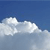 A static image of a white cloud against a blue sky background with pixelated rendering.