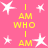 Pink background with white stars and yellow text reading "I AM WHO I AM" arranged in a pattern