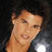 Pixelated close-up of a person's face with light skin tone, dark hair, and closed eyes against a dark background.