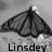 A black-and-white butterfly icon with text labels beneath it, showing a winged insect against a blurred background.