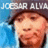 Pixelated image of a person with brown hair and light skin, wearing a dark cap, against a blue background with white text at the top.