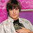 Pixelated image of a person in white jacket and black shirt against pink patterned background with red text 'zac is hot' on bright magenta