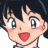Pixelated anime-style character with short dark hair, large eyes, and red cheeks, next to black background with white text.