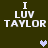 Pixelated text "I LUV TAYLOR" in white on dark green background with two heart symbols, one light purple and one gray.