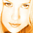 Pixelated close-up of a smiling face with warm orange and brown tones on a white background, appearing as a static AIM buddy icon.