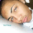 Pixelated close-up of a person's face with closed eyes, light skin, and pink lips, set against a white background with faint blue and gray accents.