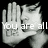 Two pixelated hands with a face behind them, displaying text across the hands against a black background.