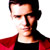 Pixelated static image of a person with dark hair wearing red and black clothing against white background.