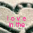 A static image shows a heart-shaped arrangement of white and dark gray elements with pink text reading 'love in the' on the left side.