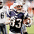 Pixelated of football players in uniforms with visible numbers and helmets, some showing open mouths or raised arms