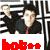 Two figures in dark clothing stand side-by-side against a black-and-white striped background with red text at the bottom.