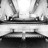Black-and-white pixelated image of a ship with multiple smokestacks and masts on water, viewed from a low angle.