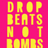 A vertical pink banner with yellow text reading "DROP BEATS NOT BOMBS" repeated twice, next to a black-and-white photo of a person holding a protest sign.