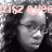 A grayscale image of a person with curly hair and glasses, overlaid with pink text in four quadrants.