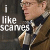 Pixelated image of a person in profile wearing glasses and a brown jacket with white trim, next to text reading 'i like scammers' on dark background.
